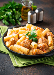 Pasta with meatballs in tomato sauce.