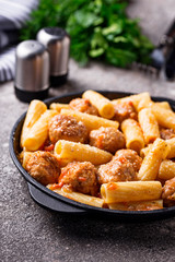 Pasta with meatballs in tomato sauce.