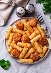 Pasta with meatballs in tomato sauce.