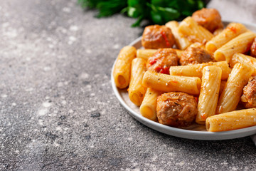 Pasta with meatballs in tomato sauce.