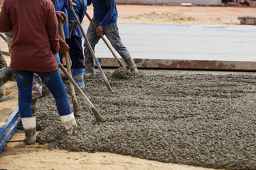 Workers are cementing for road construction