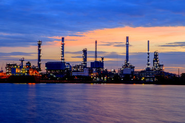 Fototapeta na wymiar Oil refinery with water reflection before sunrise