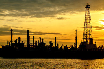 Oil refinery with water reflection before sunrise