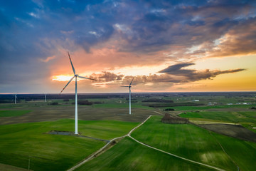 Fototapeta na wymiar Flying above stunning wind turbines at sunset