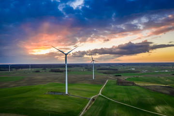 Fototapeta na wymiar Aerial view of wonderful wind turbines at dusk
