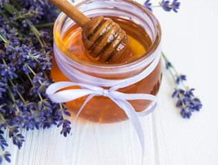 Jar with honey and fresh lavender flowers