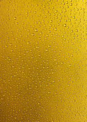 Vertical abstract water drops on gold texture background. Vertical water droplet on gold texture surface