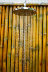 Shower head on bamboo wall
