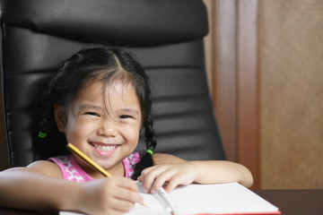 asian child student or kid girl write diligent with enjoy doing homework or learning writing note...