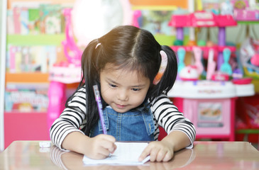 asian child cute or kid girl smiling writing or diligent review and enjoy doing mathematics homework or happy learning and training on white paper or book at nursery preschool or home and kindergarten