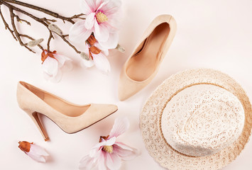 Nude colored high heels shoes and magnolia flowers