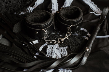 sexual toys for submission and domination in BDSM sex. Whip and handcuffs
