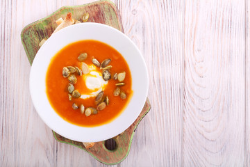 Pumpkin creamy soup with seeds served