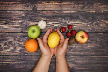 Man's hand and fruits and vegetables - Vegetarian and healthy food