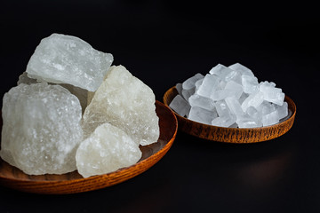 Single crystal rock sugar and polycrystalline rock sugar on black background