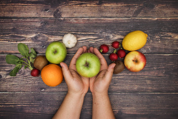 Man's hand and fruits and vegetables - Vegetarian and healthy food