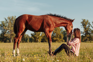 Fototapeta na wymiar portrait of young girl with a foal on the farm