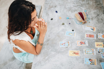 Woman is reading Tarot cards at the beach