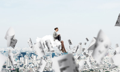 Woman float above city on cloud and papers flying around