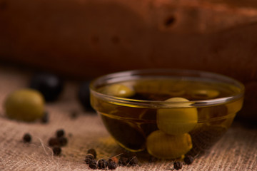 Fresh Italian baguette on wooden table with oil.Selective and soft focus