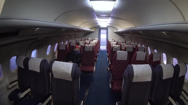 In the cabin of a large airliner. Aircraft cabin with rows of seats