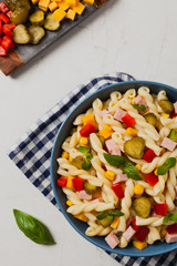 Italian fusilli pasta in a salad with ham and vegetables.
