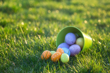 Easter eggs rolling out of bucket 