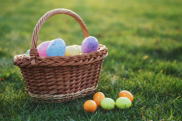 Basket full of easter eggs on green lawn