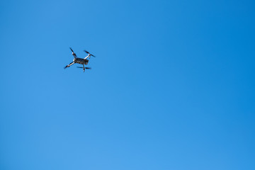 flying mechanism-drone in the blue sky, with space for text
