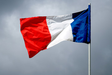 Naklejka na ściany i meble The national flag of France against the sky