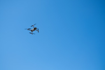 flying mechanism-drone in the blue sky, with space for text