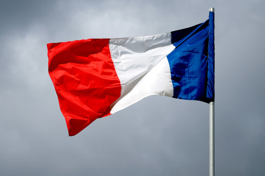 The national flag of France against the sky