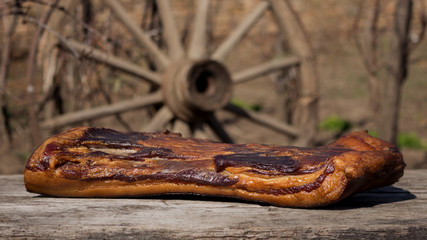 Whole Smoked Bacon Slab Resting On A Rustic Wooden Surface. Delicious Domestic Food