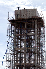 workers are building or construction water tower
