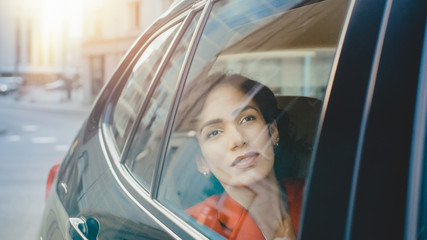 Beautiful Sad Woman Rides on a Passenger Back Seat of a Car, Looks out of the Window Dreamily. Big...