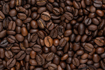 Background of dark coffee beans, top view