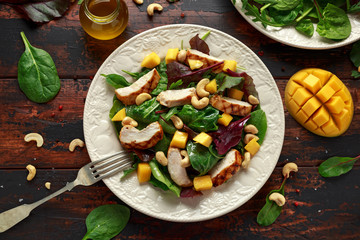 Grilled Chicken Mango salad with nuts and vegetables. Healthy food.