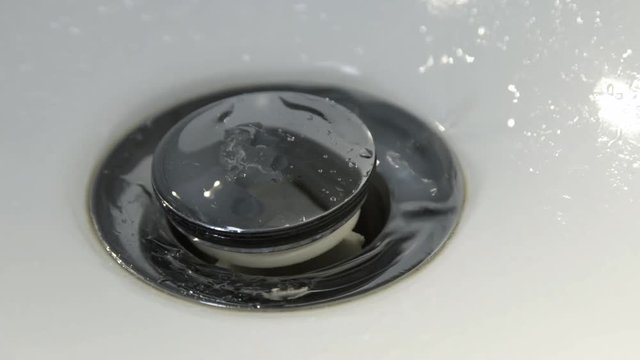 The sink with drain hole and water drops