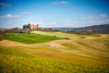 Fototapeta na wymiar View of Castle of Gallico. Beautiful landscape of hills and fields near Asciano in Tuscany, Siena, Italy