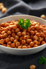 Roasted spicy chickpeas in white bowl. Healthy food