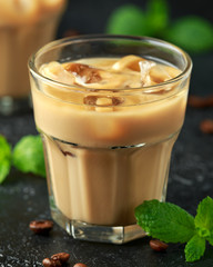 iced caramel coffee in a glass with cold milk. Summer drink