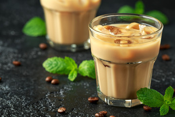 iced caramel coffee in a glass with cold milk. Summer drink