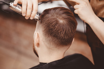 Barbershop banner. Man in barber chair, hairdresser styling his hair.