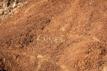 LOVE word making with stones in the desert