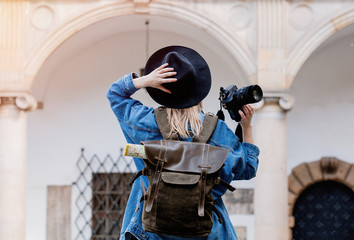 Young woman, professional photographer with camera in old castle - Powered by Adobe