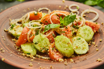 Fresh spring detox mix salad with vegetables such as tomatoes, cucumbers and onion