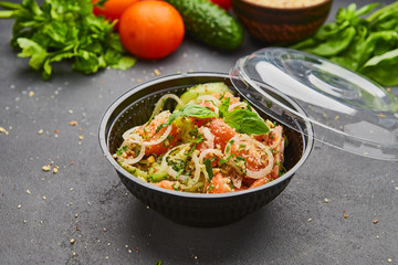 Fresh spring detox mix salad with vegetables such as tomatoes, cucumbers and onion
