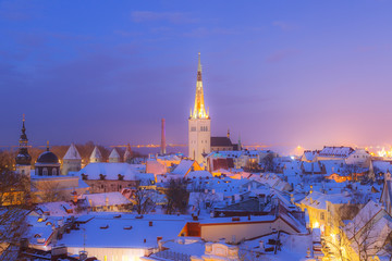 Rooftop view of old town of Tallinn, Estonia. Snowy night fairytale