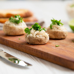 Mushroom and chicken puree with lime and toasts on wooden board, side view. Close-up. Selective focus.
