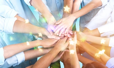 Fototapeta premium Close-up view of group of people stacking hands